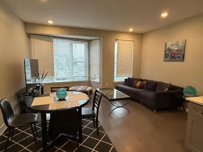 a living room with a couch and a table at Modern 2BR 2BA Apartment with rooftop in Brewerytown in Philadelphia
