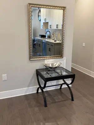 a mirror on a wall with a table in a room at Modern 2BR 2BA Apartment with rooftop in Brewerytown in Philadelphia