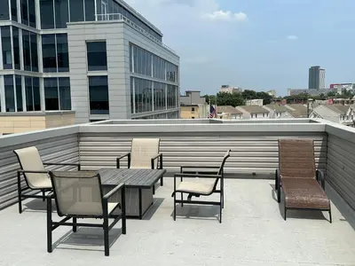 a patio with a table and chairs on a building at Modern 2BR 2BA Apartment with rooftop in Brewerytown in Philadelphia