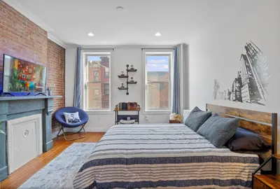 a bedroom with a large bed and two windows at Large Home - Great Location - 15 Minutes to NYC in Hoboken