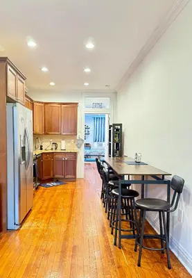 a kitchen with a table and chairs and a refrigerator at Large Home - Great Location - 15 Minutes to NYC in Hoboken