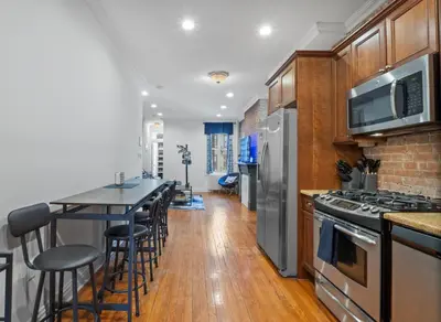 a kitchen with a counter and a bar with stools at Large Home - Great Location - 15 Minutes to NYC in Hoboken