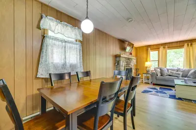 a dining room with a wooden table and chairs at Pet-Friendly Pocono Lake Cabin with Community Pool! in Pocono Lake