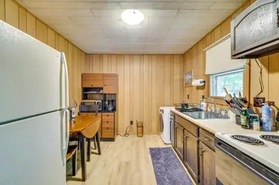 a kitchen with a refrigerator and a sink at Pet-Friendly Pocono Lake Cabin with Community Pool! in Pocono Lake