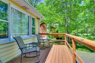 a porch with two chairs and two windows at Pet-Friendly Pocono Lake Cabin with Community Pool! in Pocono Lake