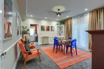 a dining room with a table and blue chairs at Charming Downtown Retreat Steps from Capitol Bldg in Harrisburg