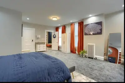 a bedroom with a blue bed in a room at Charming Downtown Retreat Steps from Capitol Bldg in Harrisburg