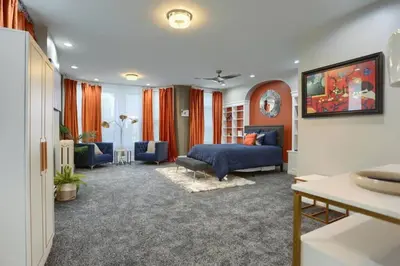 a bedroom with a bed and a living room at Charming Downtown Retreat Steps from Capitol Bldg in Harrisburg