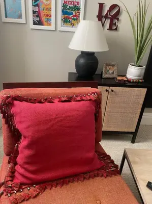 a red pillow sitting on a chair in a living room at Stylish Private 2 Bed Apt in Harrisburg