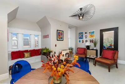 a living room with a table and blue chairs at Stylish Private 2 Bed Apt in Harrisburg