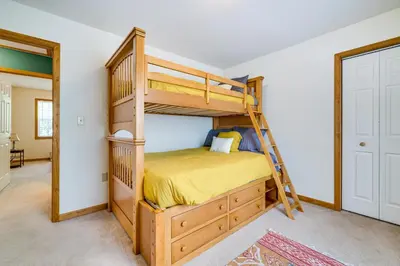 a bedroom with a bunk bed and a ladder at Deck and Screened Porch Pocono Lake Vacation Rental in Pocono Lake