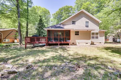 a house with a porch and a yard at Deck and Screened Porch Pocono Lake Vacation Rental in Pocono Lake