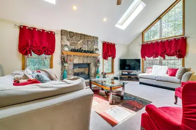 a living room with a couch and a fireplace at Deck and Screened Porch Pocono Lake Vacation Rental in Pocono Lake