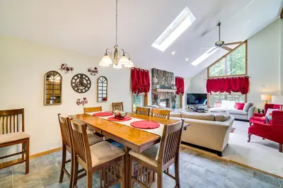 a dining room and living room with a table and chairs at Deck and Screened Porch Pocono Lake Vacation Rental in Pocono Lake