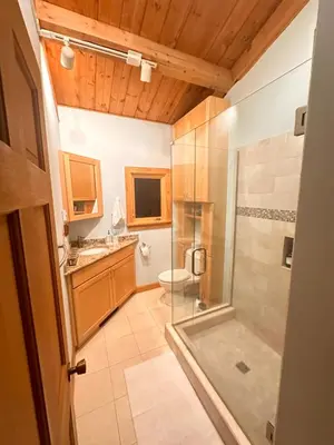 a bathroom with a shower and a toilet at Big Bear Cabin in Corning