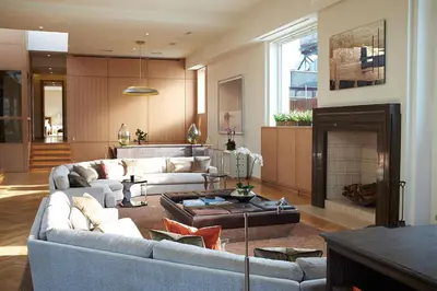 a living room with two couches and a fireplace at Rasila SoHo in New York