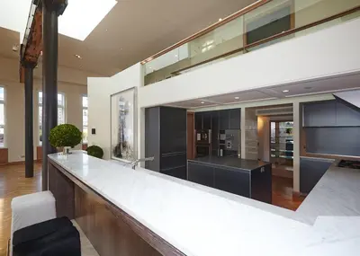 a large kitchen with a large counter top in a building at Rasila SoHo in New York