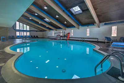 a large pool with blue water in a building at Gouldsboro Vacation Rental with Pool and Lake Access! in Gouldsboro