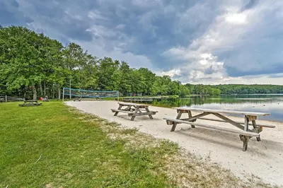 two picnic tables on the beach near the water at Gouldsboro Vacation Rental with Pool and Lake Access! in Gouldsboro