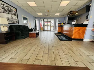 an office lobby with a couch and a desk at Travelodge by Wyndham Carlisle North in Carlisle