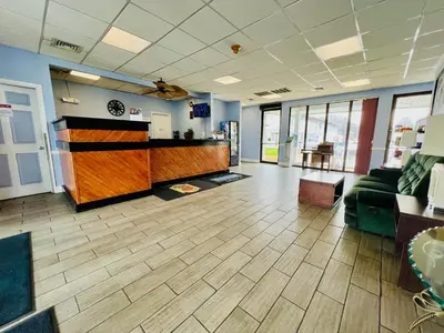 an office lobby with a couch and a counter at Travelodge by Wyndham Carlisle North in Carlisle