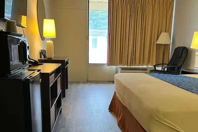 a hotel room with a bed and a television at Travelodge by Wyndham Carlisle North in Carlisle