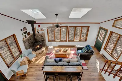 a living room with a couch and a table at Serene & Fun Family Gem ~ Big Bass Lake Community! in Gouldsboro