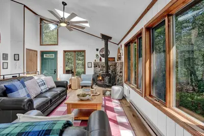 a living room with a couch and a table at Serene & Fun Family Gem ~ Big Bass Lake Community! in Gouldsboro