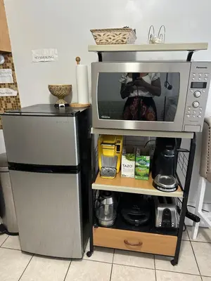 a microwave oven sitting on a shelf in a kitchen at Full bed studio near Temple and Center city Philadelphia in Philadelphia