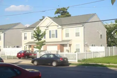 a house with cars parked in a parking lot at Full bed studio near Temple and Center city Philadelphia in Philadelphia