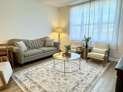a living room with a couch and a table at Luxury Condo Near NYC, MetLife & American Dream in Passaic