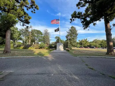 two american flags flying over a road at Luxury Condo Near NYC, MetLife & American Dream in Passaic