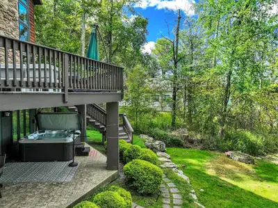 a backyard with a deck and a hot tub at Lakefront Sunsets, Hot Tub, Pool Table, Kayaks in Lake Ariel
