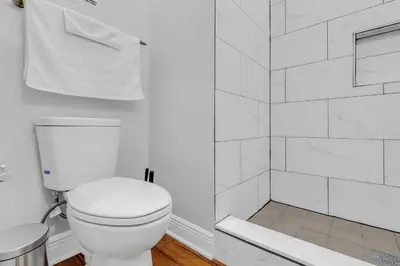 a white bathroom with a toilet and a shower at Fairmount Art Museum Center City Suites in Philadelphia