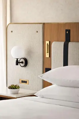 a bedroom with a bed with a lamp on the wall at Hyatt Regency New Brunswick in New Brunswick
