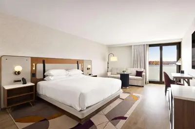 a bedroom with a bed and a living room at Hyatt Regency New Brunswick in New Brunswick