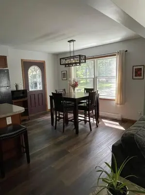 a living room with a dining room table and chairs at Falls Edge Farm Cottage in Benton