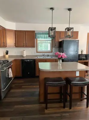 a kitchen with a island with a table and chairs at Falls Edge Farm Cottage in Benton