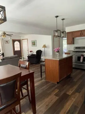 a kitchen and living room with a table and a couch at Falls Edge Farm Cottage in Benton