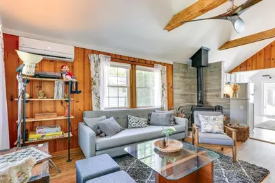 a living room with a couch and a glass table at All-Season Vernon Township Lake House Retreat! in Vernon Township