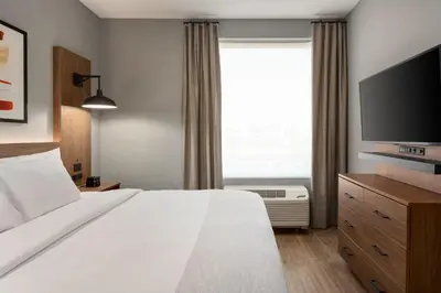 a hotel room with a bed and a large window at Hawthorn Extended Stay by Wyndham Mount Laurel Moorestown in Mount Laurel
