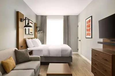 a hotel room with a bed and a tv at Hawthorn Extended Stay by Wyndham Mount Laurel Moorestown in Mount Laurel