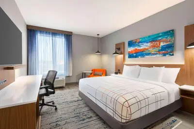 a hotel room with a bed and a desk at La Quinta Inn & Suites by Wyndham Mount Laurel Moorestown in Mount Laurel