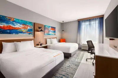 a hotel room with two beds and a kitchen at La Quinta Inn & Suites by Wyndham Mount Laurel Moorestown in Mount Laurel