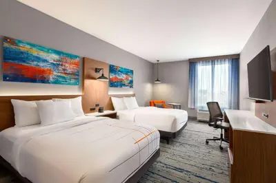 a hotel room with two beds and a desk at La Quinta Inn & Suites by Wyndham Mount Laurel Moorestown in Mount Laurel
