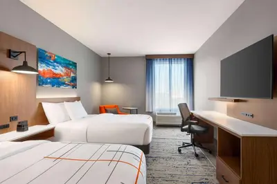 a hotel room with two beds and a flat screen tv at La Quinta Inn & Suites by Wyndham Mount Laurel Moorestown in Mount Laurel