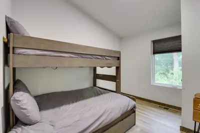 a bedroom with a bunk bed and a window at Walk to Water Park Split-Rock Resort Home with Deck in Lake Harmony