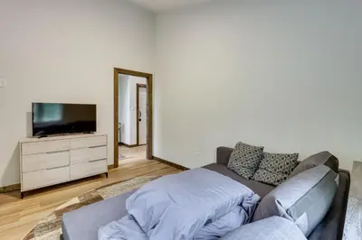 a living room with a couch and a flat screen tv at Walk to Water Park Split-Rock Resort Home with Deck in Lake Harmony
