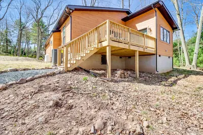 a house with a large deck on the side of it at Walk to Water Park Split-Rock Resort Home with Deck in Lake Harmony