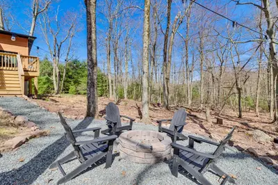 a group of chairs sitting around a fire pit at Walk to Water Park Split-Rock Resort Home with Deck in Lake Harmony